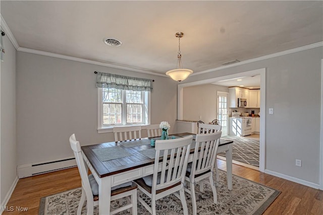 3164 Old Weymouth Rd, Medina, OH 44256 - dining room with baseboards, visible vents, a baseboard heating unit, and light wood-type flooring