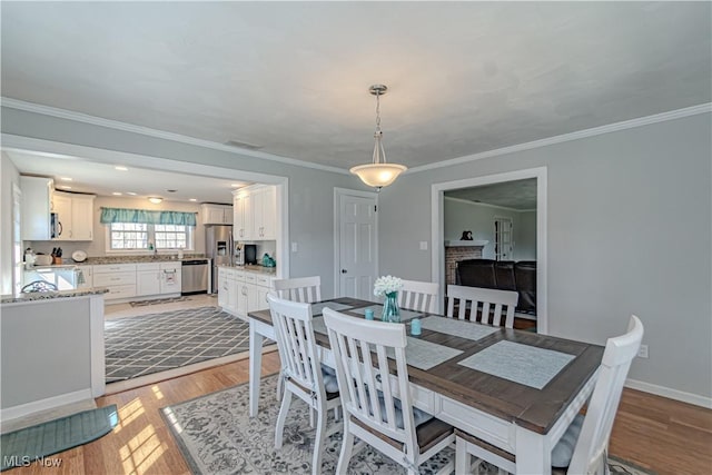 3164 Old Weymouth Rd, Medina, OH 44256 - dining space featuring ornamental molding, baseboards, and light wood-style floors