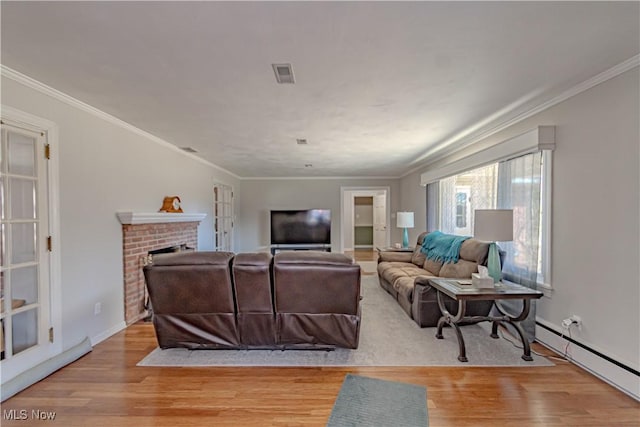 3164 Old Weymouth Rd, Medina, OH 44256 - living area featuring wood finished floors, visible vents, a brick fireplace, and baseboard heating