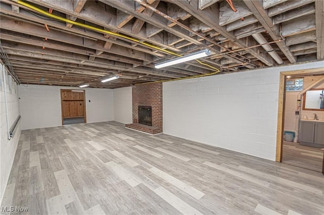 3164 Old Weymouth Rd, Medina, OH 44256 - below grade area with a sink, a fireplace, and wood finished floors