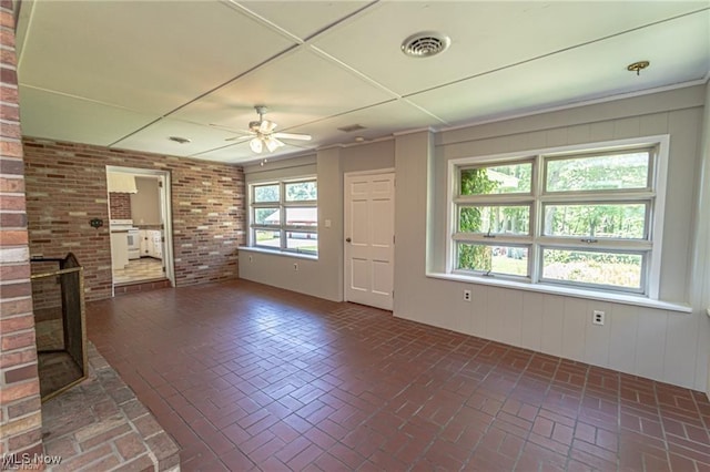 3164 Old Weymouth Rd, Medina, OH 44256 - unfurnished living room featuring a brick fireplace, brick floor, ceiling fan, and visible vents