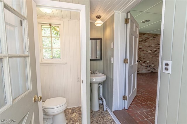3164 Old Weymouth Rd, Medina, OH 44256 - half bath with toilet, a sink, wood walls, and brick floor