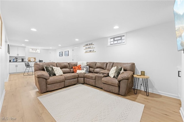 living area with recessed lighting, baseboards, and light wood-style floors