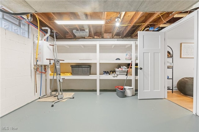 basement with concrete block wall and water heater