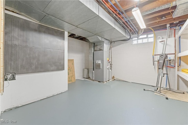 below grade area featuring concrete block wall and heating unit