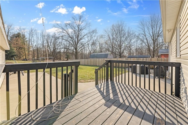 wooden deck featuring a lawn and a fenced backyard