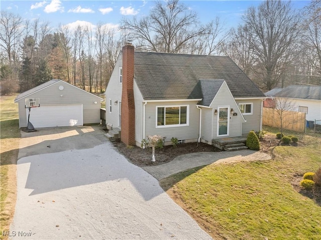 view of front of home featuring an outbuilding, fence, roof with shingles, a chimney, and a garage