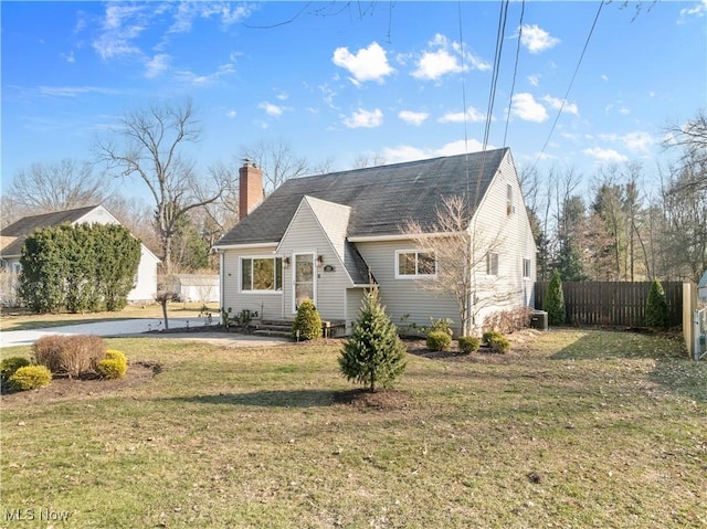 view of front of home featuring a chimney, a front lawn, and fence