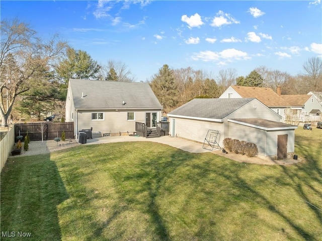 back of house featuring a yard, a patio, and fence