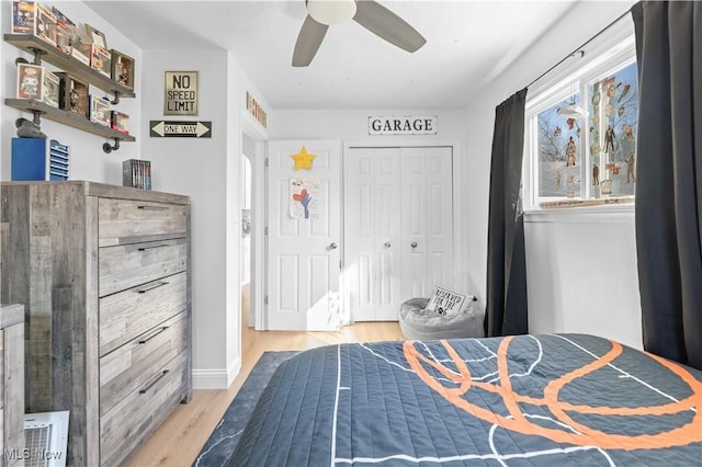 bedroom featuring a ceiling fan, light wood-style floors, and a closet