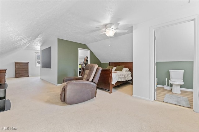 carpeted bedroom with a textured ceiling, baseboards, and vaulted ceiling