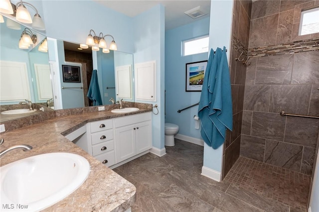 bathroom featuring double vanity, visible vents, toilet, and a sink