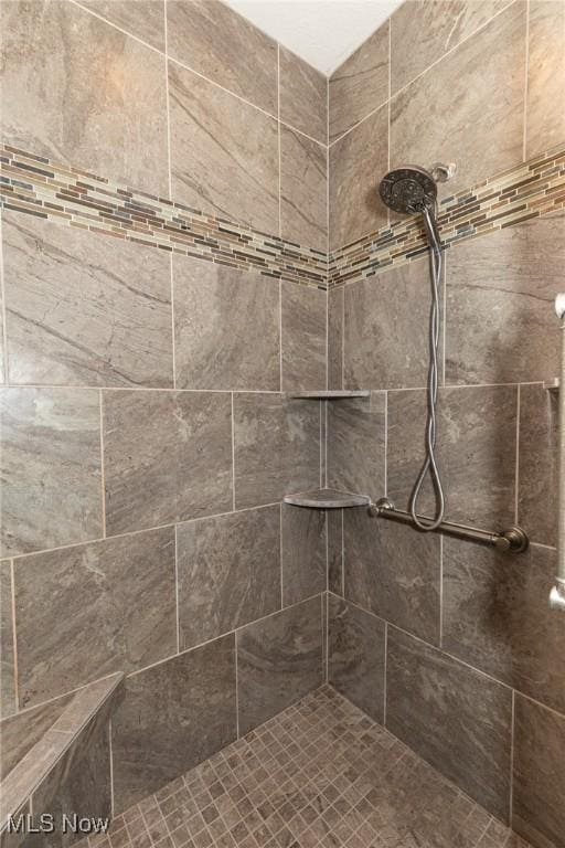 full bath featuring tiled shower