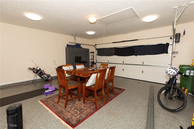 dining area with baseboards, speckled floor, and a textured ceiling