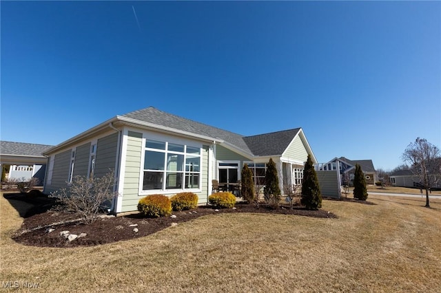 view of side of property with a yard