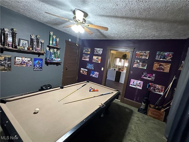 playroom with baseboards, carpet flooring, a textured ceiling, washer / clothes dryer, and a ceiling fan