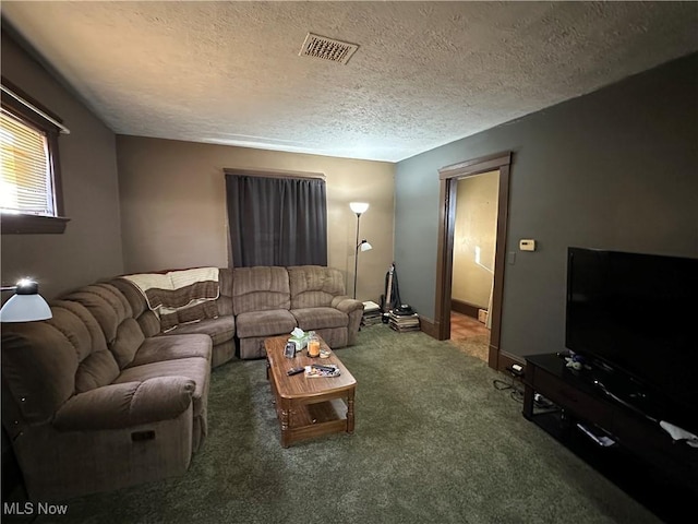 carpeted living area with baseboards, visible vents, and a textured ceiling