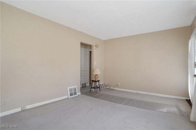 spare room featuring visible vents, baseboards, and carpet floors