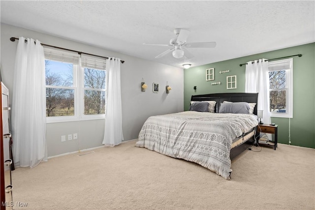 carpeted bedroom with visible vents, a textured ceiling, and ceiling fan