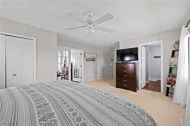 bedroom featuring ceiling fan, carpet, french doors, a closet, and a textured ceiling