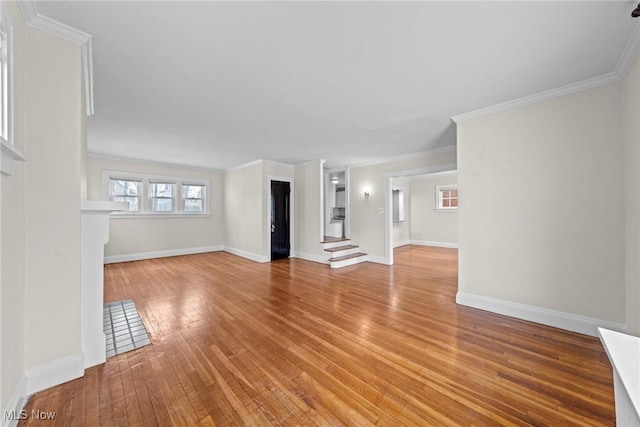 unfurnished living room featuring crown molding, stairway, light wood-style floors, and baseboards