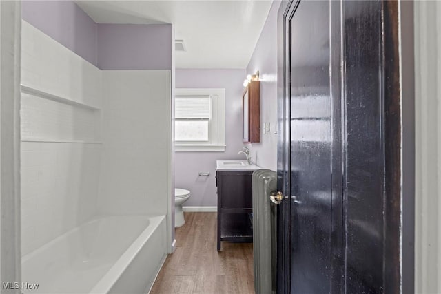 full bathroom with vanity, toilet, wood finished floors, and baseboards