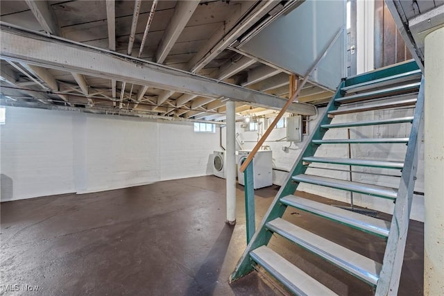 basement with electric panel, stairway, and washer / clothes dryer