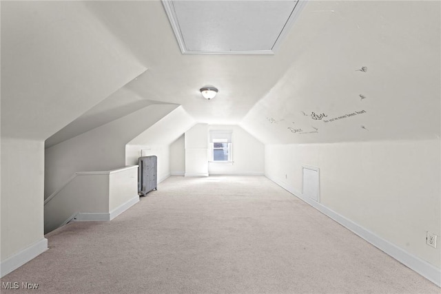 bonus room with attic access, carpet flooring, baseboards, and lofted ceiling