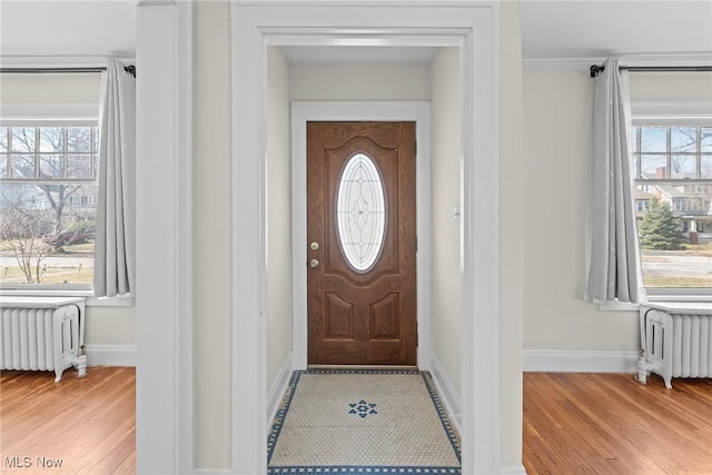 interior space featuring light wood-type flooring, baseboards, and radiator