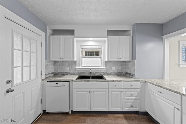 kitchen featuring a sink, dark wood-style floors, white dishwasher, and white cabinetry