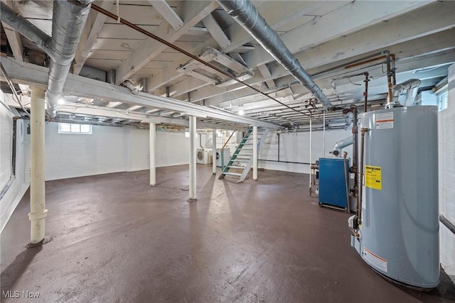 basement featuring a heating unit, gas water heater, and washer / clothes dryer