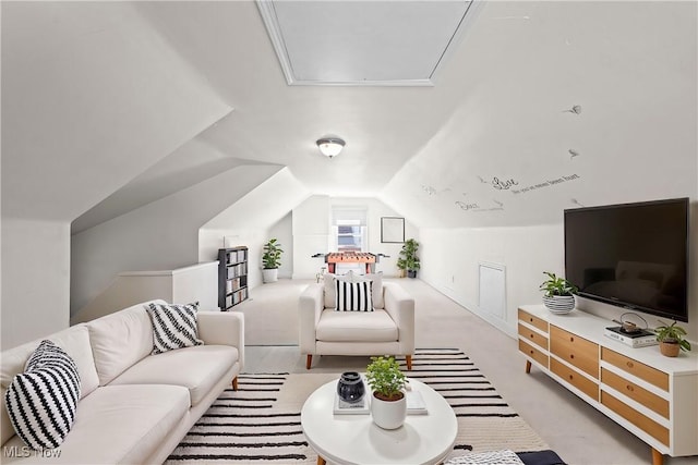 living room with carpet flooring, attic access, and lofted ceiling