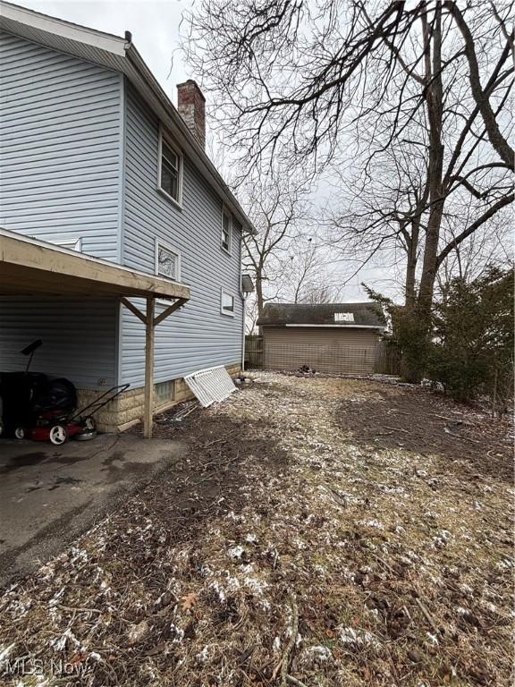 1325 Maddrell Ct NE, Canton, OH 44705 - view of side of home featuring a chimney