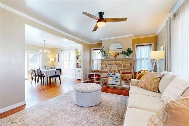 living room featuring wood finished floors, baseboards, and a wealth of natural light