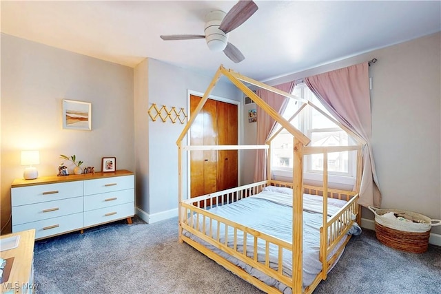 carpeted bedroom featuring baseboards and a ceiling fan