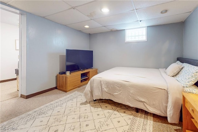 bedroom with a drop ceiling, recessed lighting, light colored carpet, and baseboards