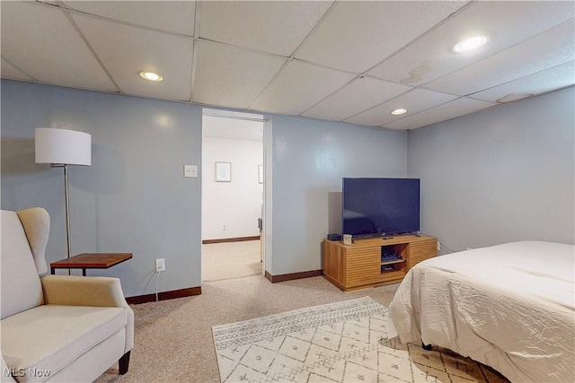 bedroom featuring recessed lighting, baseboards, a drop ceiling, and light carpet