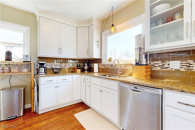 kitchen with dishwasher, light wood-style flooring, light stone countertops, and white cabinetry