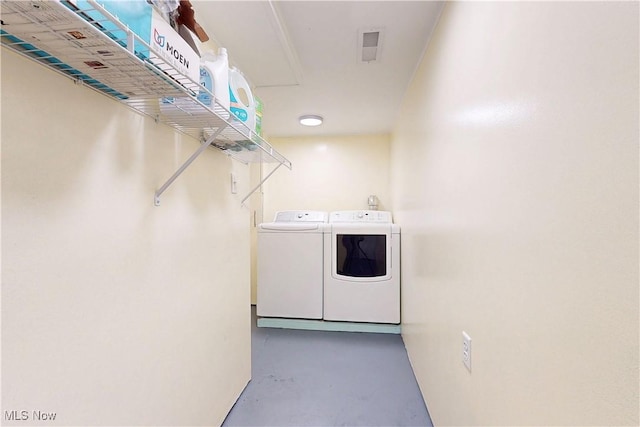 washroom featuring laundry area and separate washer and dryer