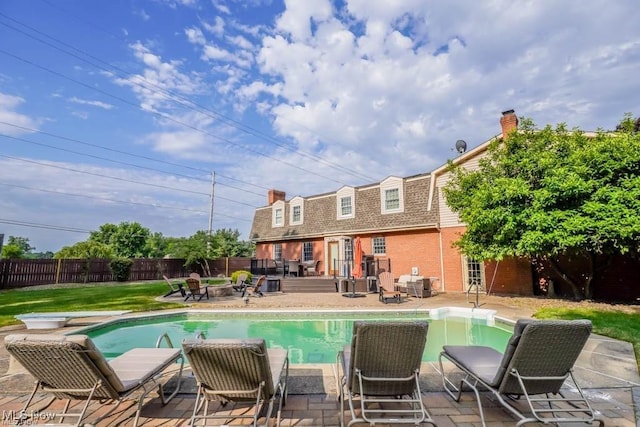 view of pool featuring a patio, a fenced in pool, a diving board, and a fenced backyard