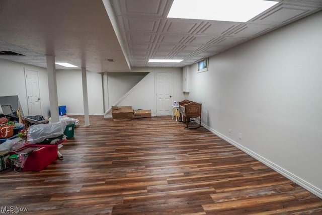 finished basement featuring baseboards and wood finished floors