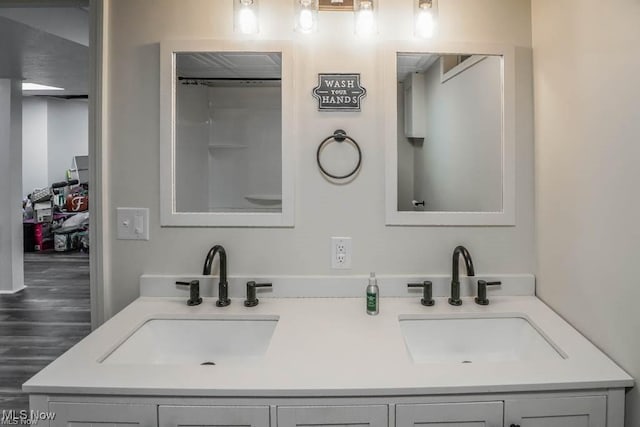 full bathroom featuring a sink and double vanity