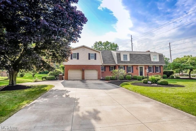 view of front of home featuring a front yard, a gambrel roof, concrete driveway, a garage, and brick siding