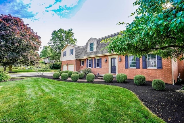 view of front of home featuring a front yard, a garage, brick siding, and roof with shingles