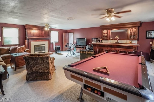 recreation room featuring a ceiling fan, carpet floors, a fireplace, pool table, and a dry bar