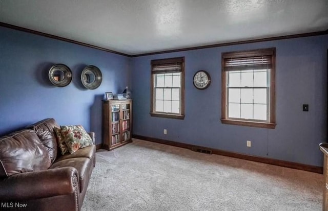 sitting room with visible vents, baseboards, carpet floors, a textured ceiling, and crown molding