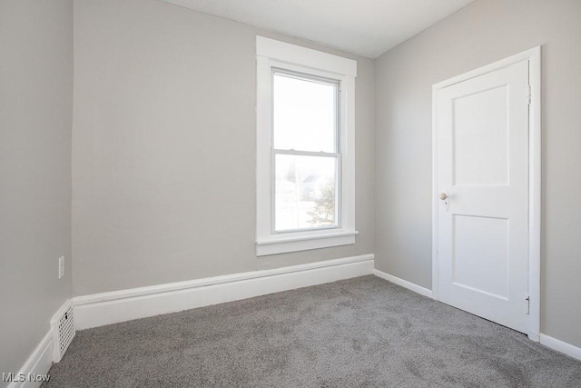 unfurnished room with visible vents, baseboards, and carpet