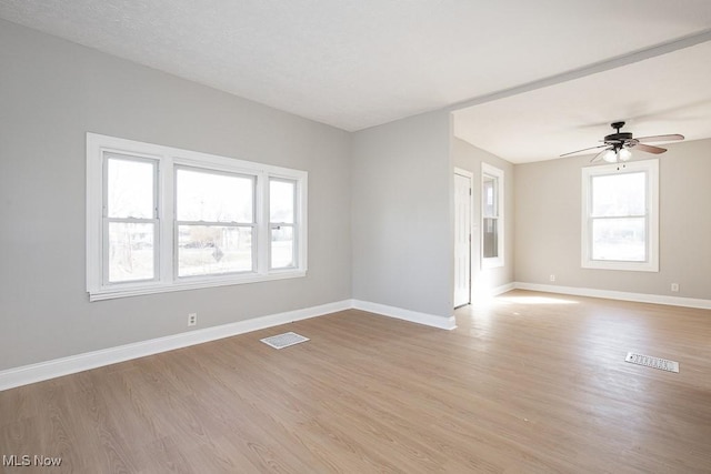 unfurnished room with visible vents, baseboards, and light wood-style flooring