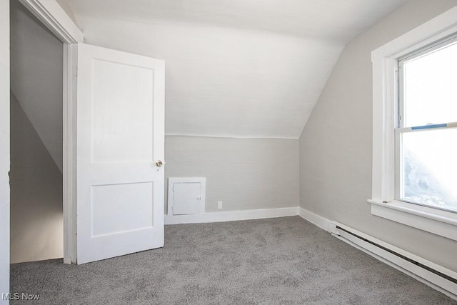 additional living space featuring carpet flooring, baseboards, a baseboard heating unit, and lofted ceiling