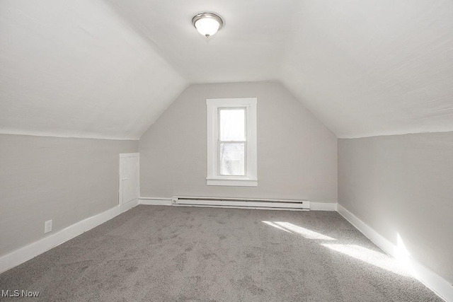 additional living space featuring lofted ceiling, carpet, a baseboard heating unit, and baseboards